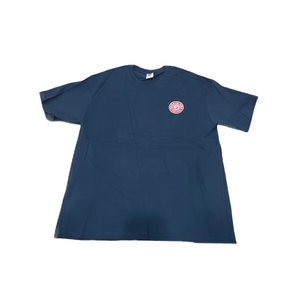 A Black short-sleeve t-shirt with a small circular red and white graphic printed on the left chest, laid flat against a white background